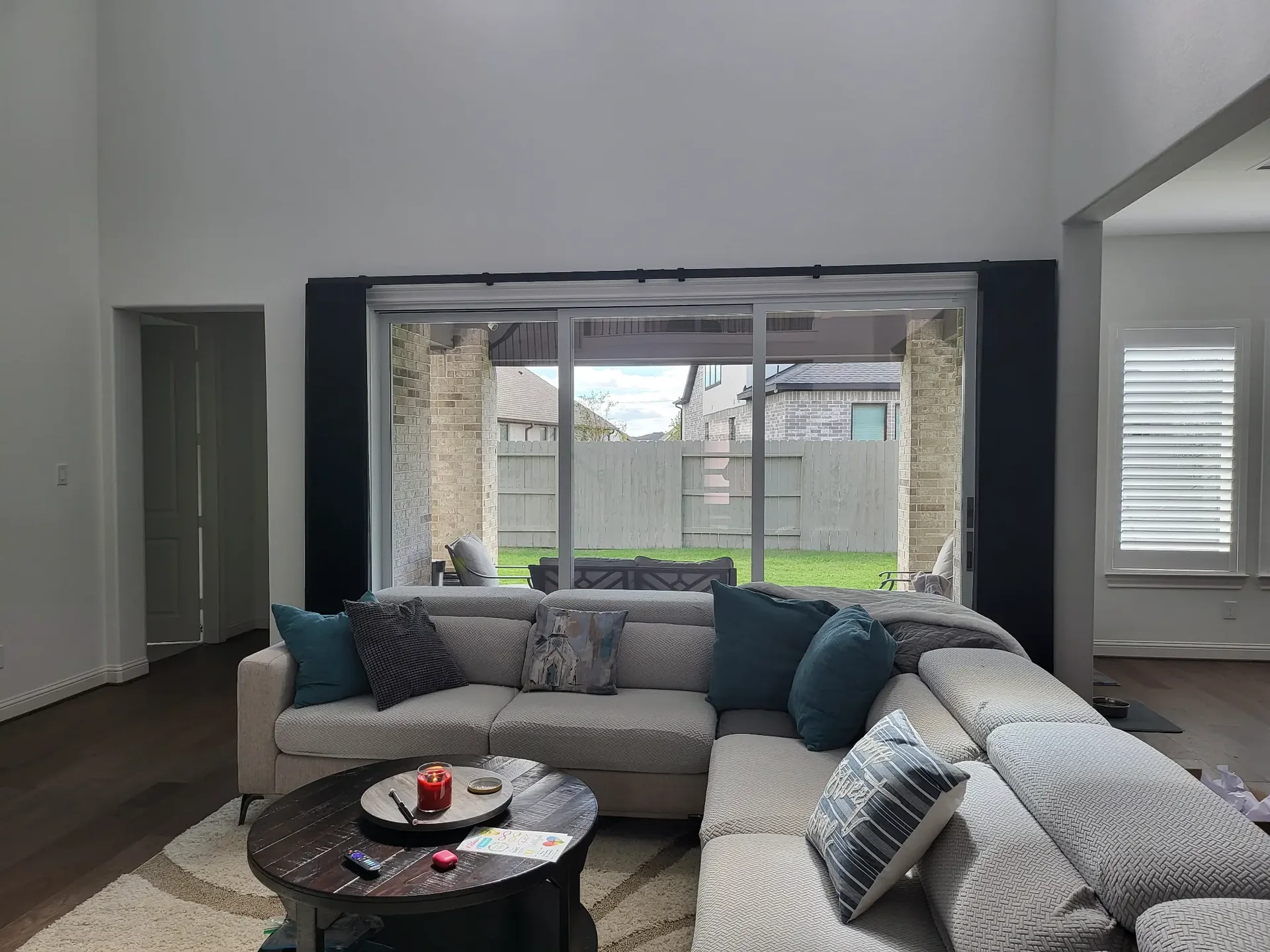 Living room with drapes and plantation shutters — The Blinds Tech