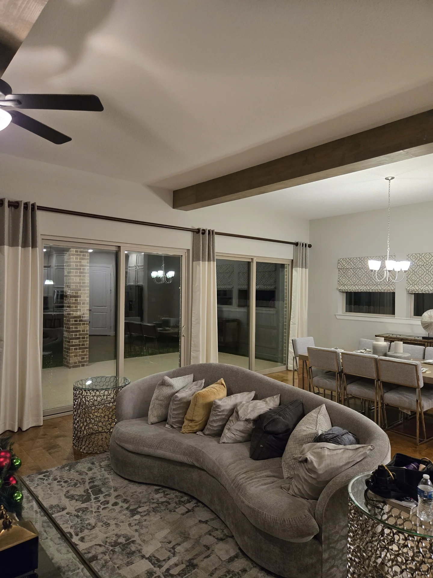 Open-plan living and dining with drapes and roman shades — The Blinds Tech